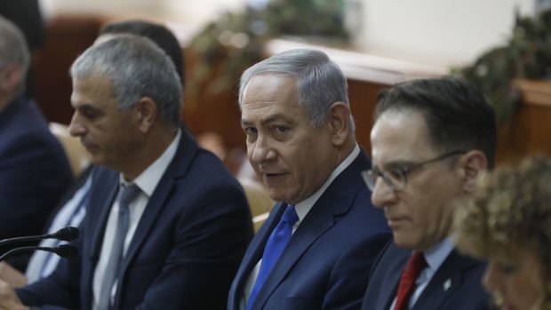 Benjamin Netanyahu sits next to Israeli Finance Minister Moshe Kahlon, left.