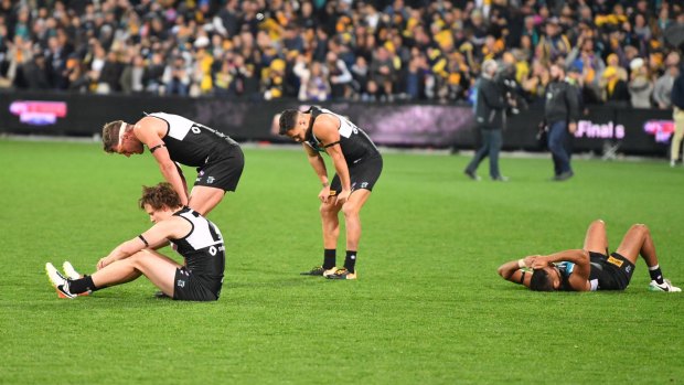 Port's players are shattered after the extra-time loss to West Coast in their elimination final.