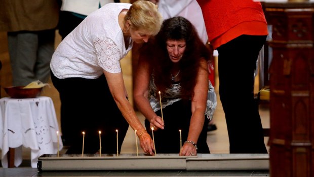 Members of the congregation at the commemoration service lit candles for those who died during the earthquake.