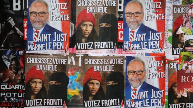 Posters for far right anti-immigration party National Front state in Paris earlier this month.