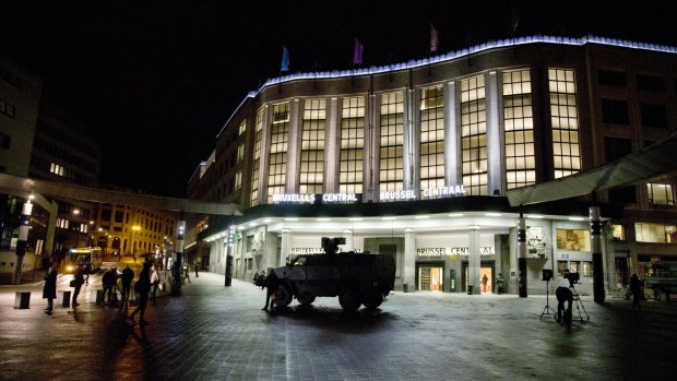 An army vehicle is parked outside the Belgian capital's main train station on Saturday night. The cobblestone square is usually crowded with revellers.
