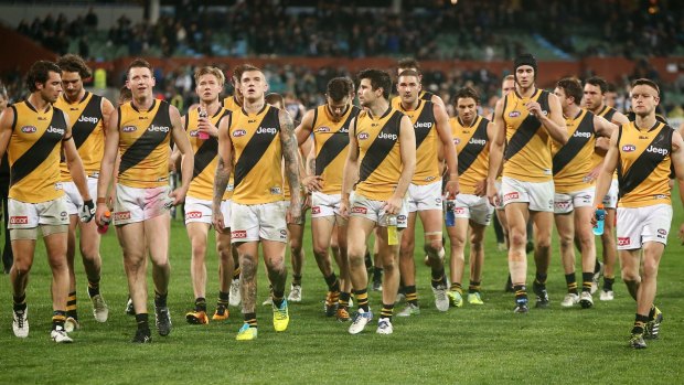 Dejected Tigers leave the field after losing to Port Adelaide.