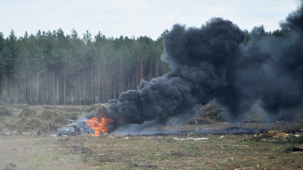 The Russian military helicopter burns after crashing.