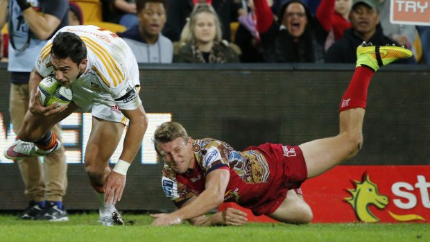 Hosea Gear of the Chiefs (L) scores a try against James Slipper of the Reds at Suncorp Stadium.