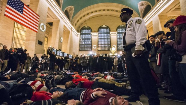 A police officer stands over activists last year staging a die-in and demanding justice for the death of Eric Garner in New York.