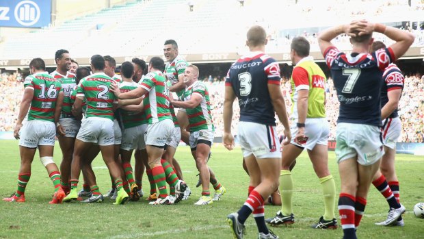 Jubilation: The Rabbitohs celebrate with Hymel Hunt after he scored a try during the round one NRL match between the Sydney Roosters and South Sydney at Allianz Stadium.