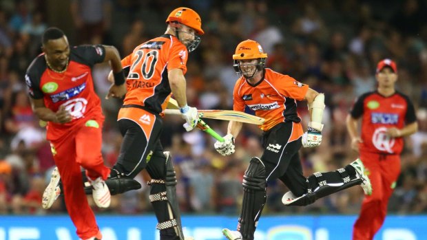 Michael Klinger and Shaun Marsh of the Scorchers take a single as Dwayne Bravo scurries back to try and effect a runout.