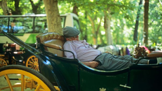 Taking a siesta in a carriage in Seville, Spain.