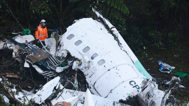 Rescue workers search at the wreckage site.