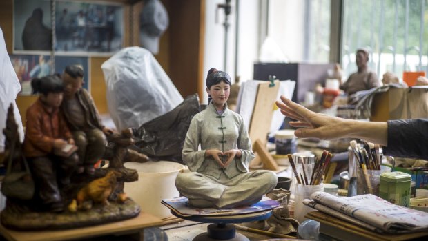 A clay figure being created by clay maker Lin Gang to promote traditional Chinese values.
