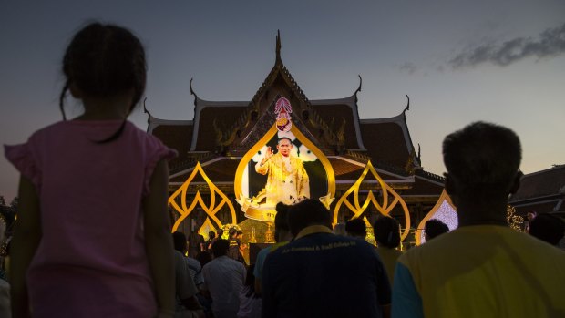 Crowds gather to watch a puppet show about his life near the Grand Palace as the celebration for Thailand's King Bhumibol Adulyadej's 88th birthday began earlier this month. 