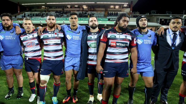 In the firing line: Force and Rebels players provide a show of unity following their final game of the Super Rugby season. One team will go. But is that enough?