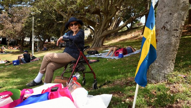 Birgitta Sharpe sits near a Swedish flag marking her picnic spot in Bronte Park.