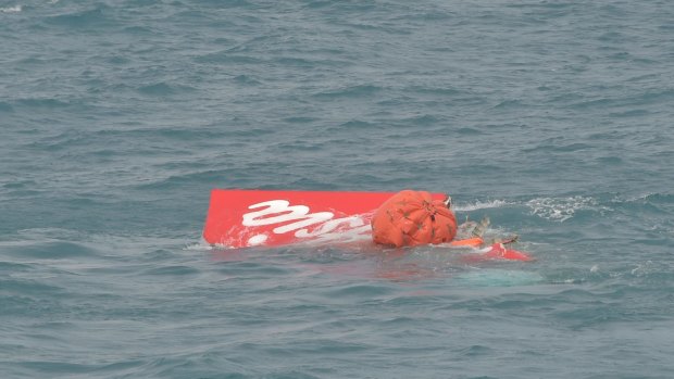 Part of the tail of AirAsia flight QZ8501 floats on the water's surface.