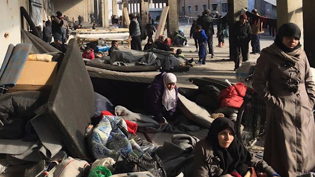 Syrians displaced with their families from eastern Aleppo gather at a collective shelter in Jibreen, south of Aleppo, on Monday.