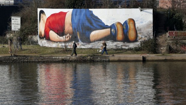 A graffiti showing drowned three year old refugee Aylan Kurdi was created by the river Main in Frankfurt, Germany.  The boy was found dead last year after a number of migrants died while boats carrying them to Europe capsized.