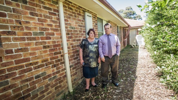 Macquarie couple Greg and Melissa Wilson are worried about asbestos contamination after flash floods from the neighbouring Mr Fluffy block bought torrents of water and debris into their yard. Pictured in the area that was under water during the floods. 