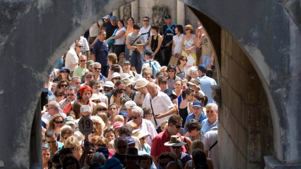 Tourists queue to get out of the old walled city of Dubrovnik in Croatia.