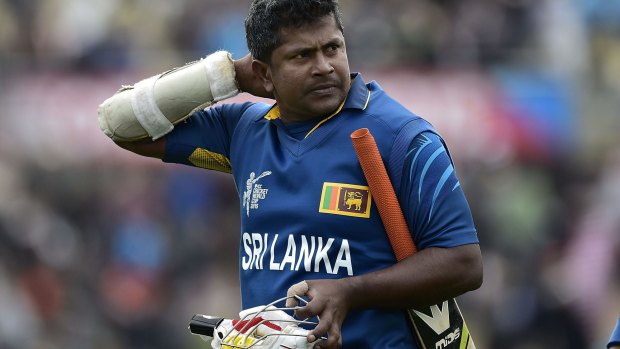 Rangana Herath walks from the field after being caught out, ending the Sri Lankan innings.