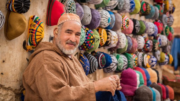 A man making and selling hats and in Essaouira, Morocco.