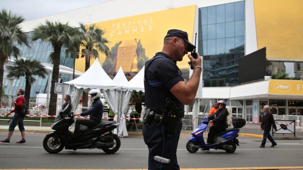 A police officer patrols in front of the entrance of the Festival Palace in Cannes on Tuesday.