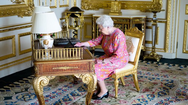 The Queen at her desk in Windsor Castle.