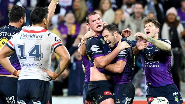 Storm's Joe Stimson is hugged by captain Cameron Smith after his match-winning try against the Roosters.