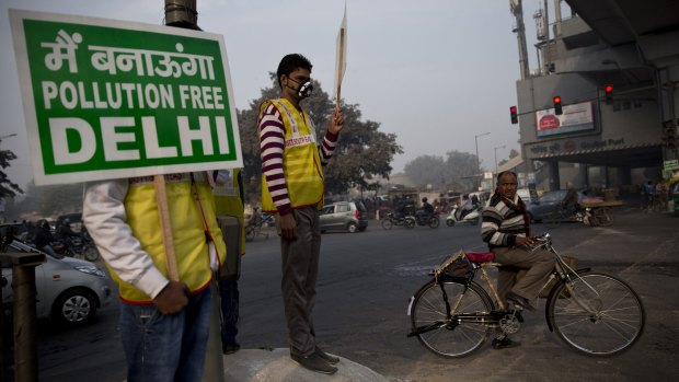 Volunteers display placards reading: 'We will make a pollution free Delhi' during a two-week experiment to reduce the number of cars to fight pollution in India, in January. 