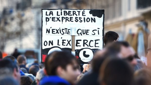 A sign that reads in French, "Freedom of expression does not exists unless we exercise it" during a march in the southeastern city of Marseille on Saturday.