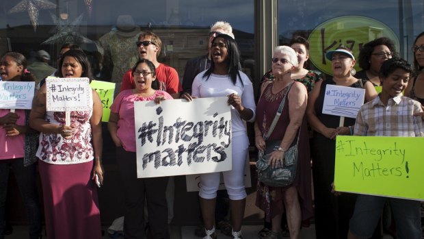 People protest against Rachel Dolezal in front of the National Association for the Advancement of Coloured People (NAACP) headquarters in Spokane.