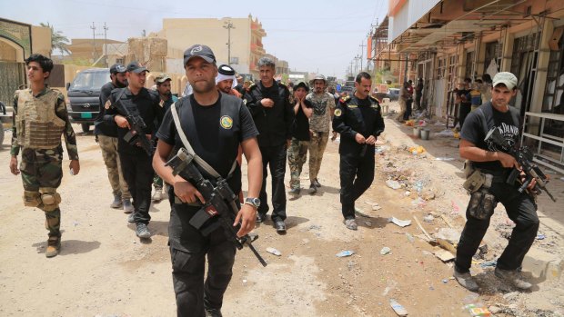 Iraqi security forces patrol Fallujah on Tuesday. 