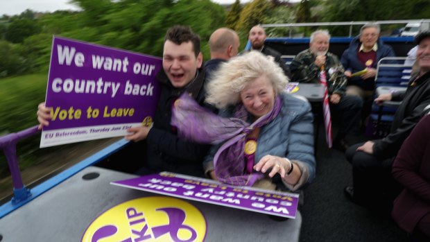 Vote Leave supporters battle with the wind near Sheffield, in England, as they travel on the battle bus of UKIP leader Nigel Farage  campaigning for votes to leave the EU.