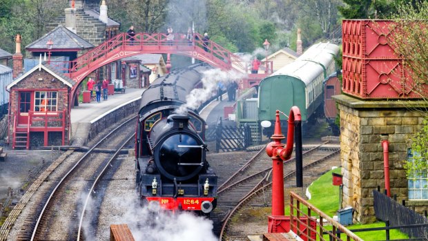 A vintage passenger steam train leaves Goathland Station on the way to Whitby on the North Yorkshire Moors Railway.