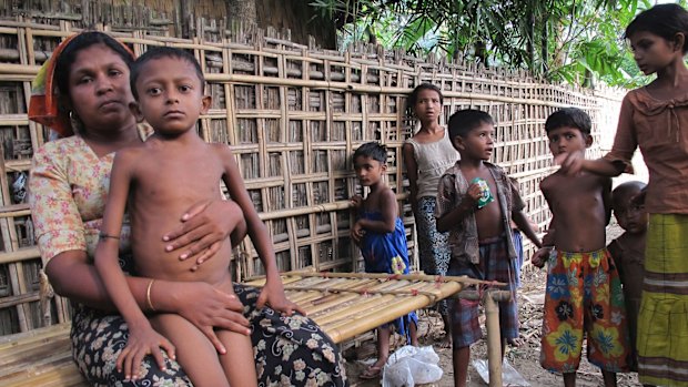 Salema Khatu, left, wraps her arms around her son Habil, who was suffering from tuberculosis, in Rakhine state, Myanmar, in 2014.