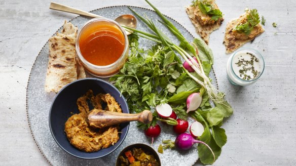 Abgoosht served with flatbread and salad.