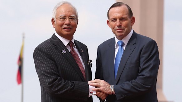 Malaysian Prime Minister Najib Razak, pictured here with  Australian Prime Minister Tony Abbott,  is under pressure in his home country to resign because of a series of corruption scandals.