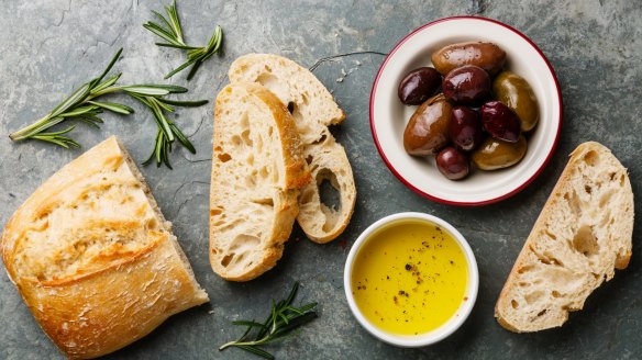 Fresh ciabatta with olive oil and olives.
