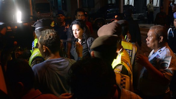 A representative from the Brazilian embassy (centre) leaves after the executions at Nusakambangan prison on Sunday, the first under Indonesian President Joko Widodo.