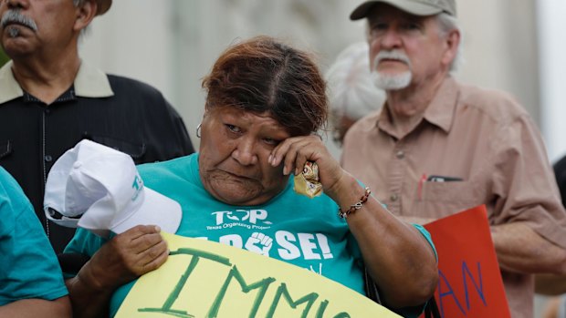 Eldia Contreras wipes away a tear as she takes part in a vigil at San Fernando Cathedral for victims who died as a result of being transported in truck on Sunday.