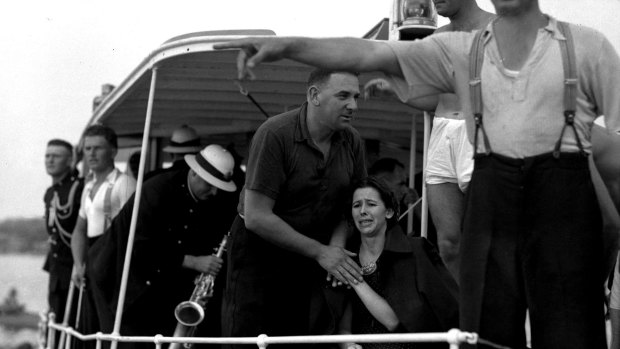 A woman is comforted on board the police launch Cambria.