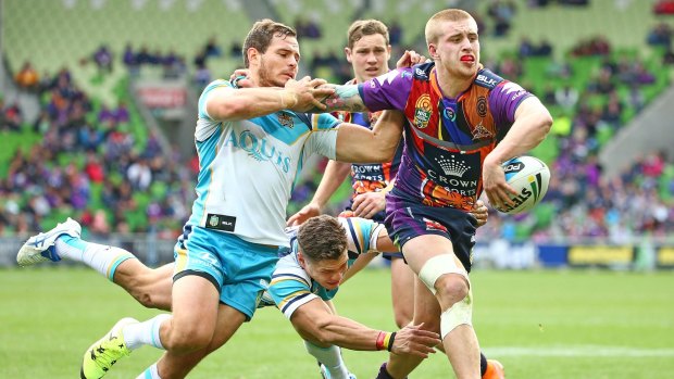 Cameron Munster is tackled just short of the try line during the match against Gold Coast.