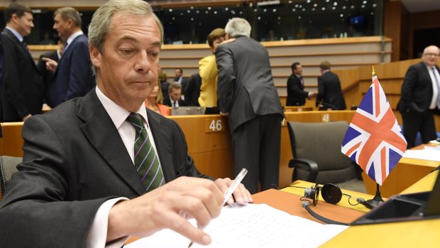 UKIP leader Nigel Farage sits next to a British flag during a special session of the European Parliament on June 28.