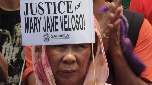A protester holds a placard calling for justice for Filipina drug convict Mary Jane Veloso during a protest outside the presidential palace in Manila on Wednesday.