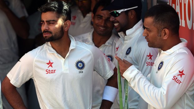An eye to the future: Virat Kohli (left) and the man he replaced, M.S. Dhoni.