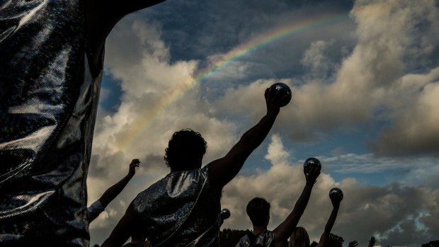 Rainbow connection: The symbol for gay pride obligingly emerges as the Sydney Queer Irish practise their moves.