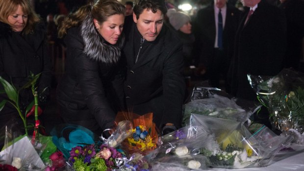 Canadian Prime Minister Justin Trudeau and his wife Sophie Gregoire Trudeau place flowers at a makeshift memorial on Monday.