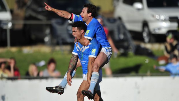 Queanbeyan Blues players Tom Ruediger and Ben Nicoll celebrate a try in last year's grand final win over Goulburn.  