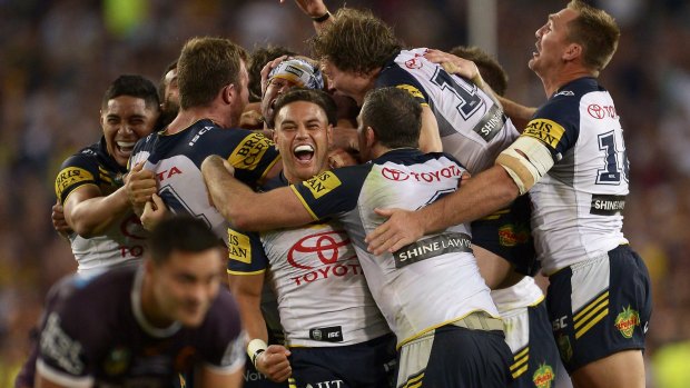 The Cowboys players celebrate their victory - and Johnathan Thurston emerged with a gash above his eye. 
