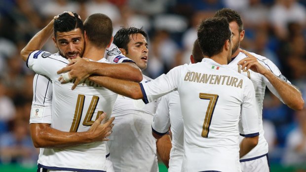 Italy's players celebrate their opening goal against Israel.