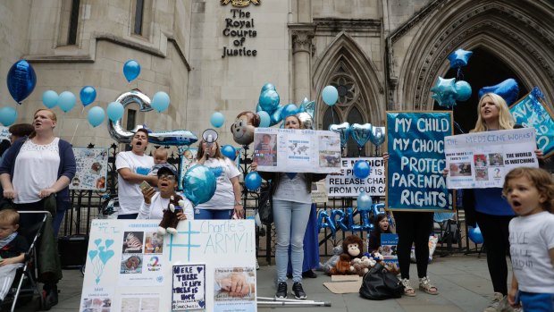 Supporters of Charlie Gard hold placards outside the court in London.